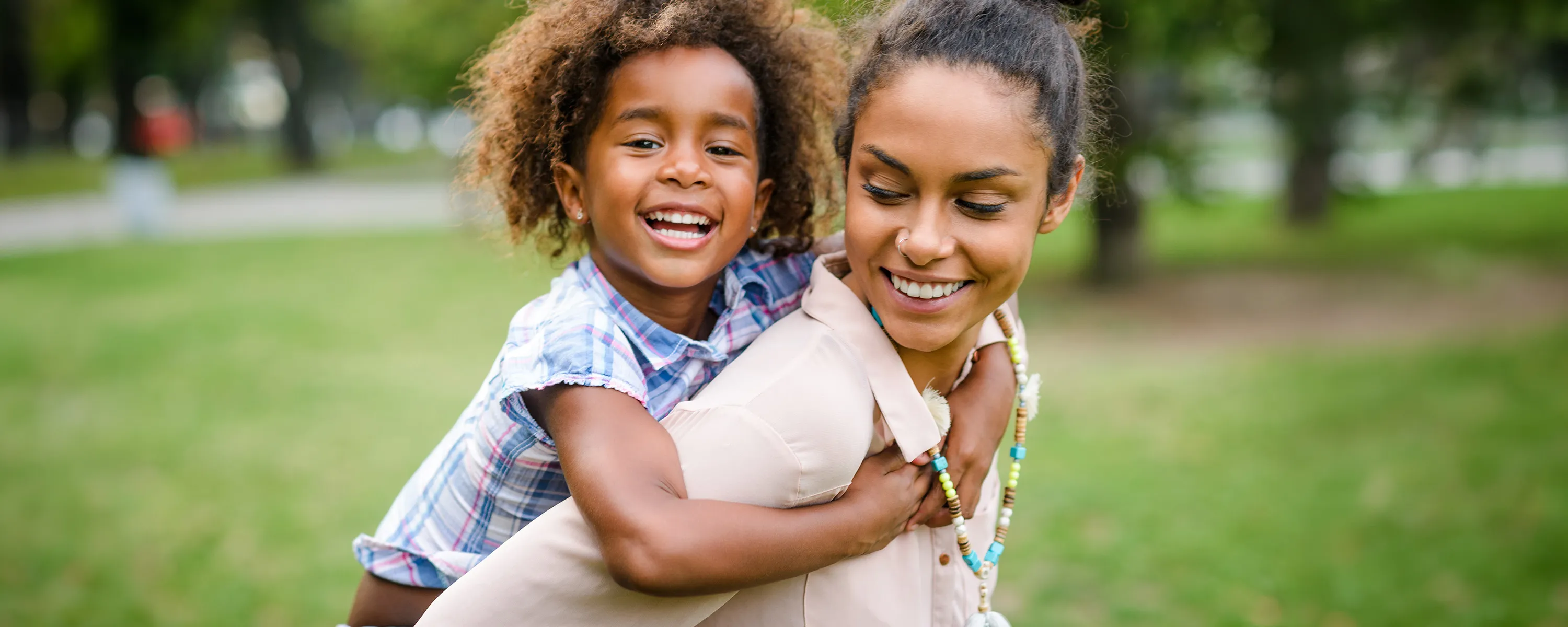 Mother giving daughter a piggy back