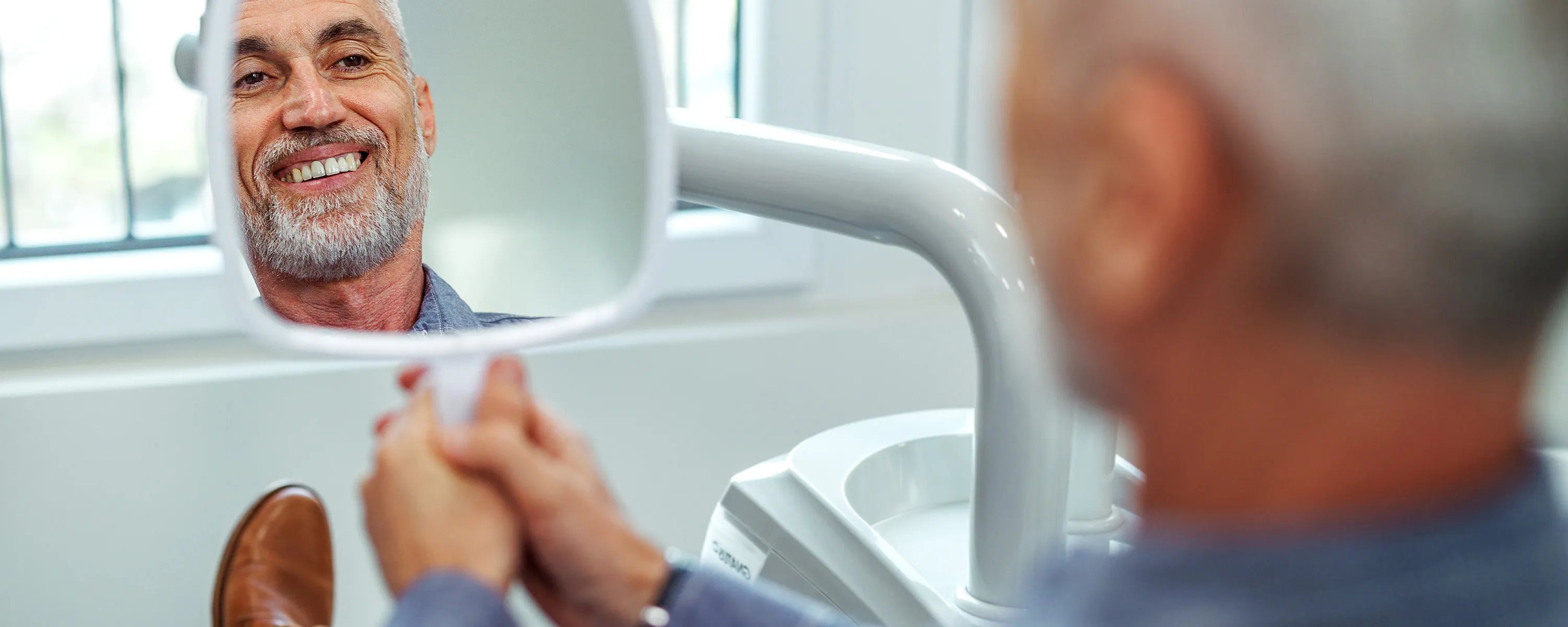 Dental patient admiring work done